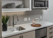 Thumbnail 21 of 33 - a kitchen with a sink and a microwave
