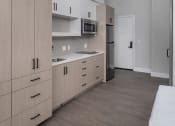 Thumbnail 24 of 33 - a kitchen with a stove top oven next to a refrigerator
