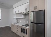 Thumbnail 33 of 33 - a kitchen with white cabinets and a stainless steel refrigerator