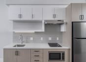 Thumbnail 31 of 33 - a kitchen with a sink microwave and refrigerator