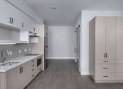 Thumbnail 30 of 33 - a kitchen with a sink and a refrigerator