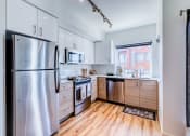 Thumbnail 15 of 21 - a kitchen with stainless steel appliances and white cabinets at Wilcox, Seattle, 98107