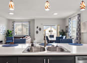 Thumbnail 2 of 24 - A modern kitchen with a large island and a view of the living room.