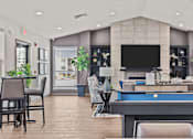 Thumbnail 15 of 24 - A well-lit room with a pool table and a television.
