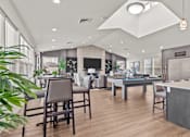 Thumbnail 16 of 24 - A modern office space with wooden floors and grey furniture.