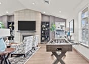 Thumbnail 17 of 24 - A modern living room with a fireplace and a television.