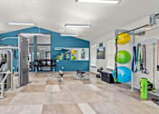 Thumbnail 21 of 24 - A gym with a variety of equipment including a squat rack, a bench press, and a treadmill.