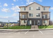 Thumbnail 23 of 24 - A two-story building with a parking lot in front.