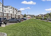 Thumbnail 10 of 34 - a green lawn in front of a row of houses