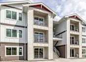 Thumbnail 5 of 34 - a row of town homes with stairs and balconies