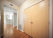 Thumbnail 21 of 47 - A hallway with a wooden floor and a wooden door.