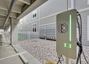 Thumbnail 9 of 23 - A parking garage with a charging station for electric vehicles.