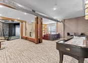 Thumbnail 19 of 35 - a game room with a pool table and a bar