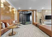 Thumbnail 20 of 35 - a living room with couches and a glass shower
