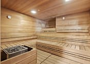 Thumbnail 24 of 35 - a sauna with wooden walls and benches and a window