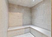 Thumbnail 25 of 35 - A corner of a room with a bench and tiled walls.