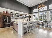 Thumbnail 26 of 35 - A modern kitchen with a large island and bar stools.