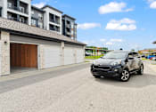 Thumbnail 30 of 35 - a car is parked in front of a building