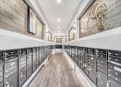 Thumbnail 10 of 43 - A long hallway with a series of drawers on the side and a wooden floor.