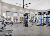 Thumbnail 14 of 43 - A spacious gym with a variety of equipment including treadmills, elliptical machines, and weight racks.