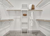 Thumbnail 33 of 43 - A white closet with a shelf and a basket on top.