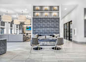 Thumbnail 7 of 43 - A modern living room with a grey sofa and two chairs.
