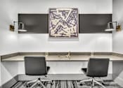 Thumbnail 8 of 43 - A modern office with a large abstract painting on the wall.
