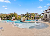 Thumbnail 23 of 92 - A large outdoor swimming pool with a fountain in the middle.