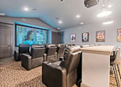 Thumbnail 39 of 92 - A home theater with a screen and multiple chairs.