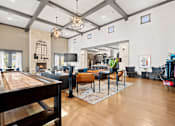 Thumbnail 50 of 92 - A well-lit, spacious living room with a pool table and a variety of seating options.
