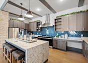 Thumbnail 62 of 92 - A kitchen with a marble island and a blue backsplash.