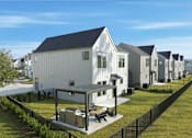 Thumbnail 23 of 63 - A row of houses with a black fence in front.