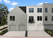 Thumbnail 20 of 63 - A modern house with a grey and white exterior and a black roof.