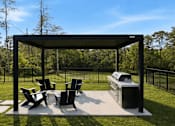 Thumbnail 12 of 63 - A black metal and concrete patio with a table and chairs.