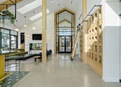 Thumbnail 9 of 63 - A modern interior with a white brick wall and a wooden staircase.