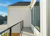 Thumbnail 6 of 63 - A white garage with a black railing and a window.