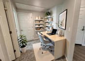 Thumbnail 9 of 10 - A room with a desk, chair, and bookshelf.