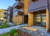 Thumbnail 10 of 13 - A modern building with wooden slats on the exterior.