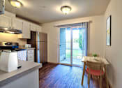 Thumbnail 12 of 36 - Parc East Apartments Staged kitchen and small dining area