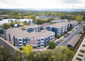 Thumbnail 4 of 20 - an aerial view of an apartment complex with cars parked in a parking lot