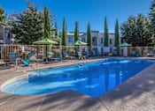 Thumbnail 8 of 14 - Port Royale Luxury Apartment Homes in Sierra Vista, Arizona Pool with Lounge Chairs