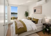 Thumbnail 7 of 23 - a bedroom with a large window and a bed at Liza Apartments, Seattle, Washington