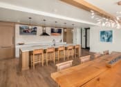 Thumbnail 14 of 23 - a kitchen and dining room with a wooden table and chairs at Liza Apartments, Seattle