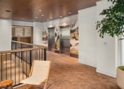 Thumbnail 20 of 23 - the lobby of a hotel with a chair and a tree at Liza Apartments, Seattle, 98102
