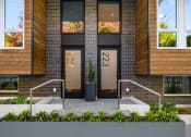 Thumbnail 22 of 23 - the facade of a building with brick and glass doors at Liza Apartments, Seattle