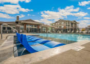 Thumbnail 32 of 45 - RedPoint Apartments Pool with Lounge Chairs