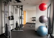 Thumbnail 8 of 15 - a fitness room with exercise equipment and a ball