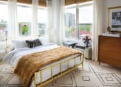 Thumbnail 3 of 15 - a bedroom with a bed and large windows