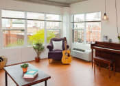Thumbnail 2 of 15 - a living room with a guitar and a piano