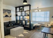 Thumbnail 2 of 10 - a living room and dining room with a couch and a table